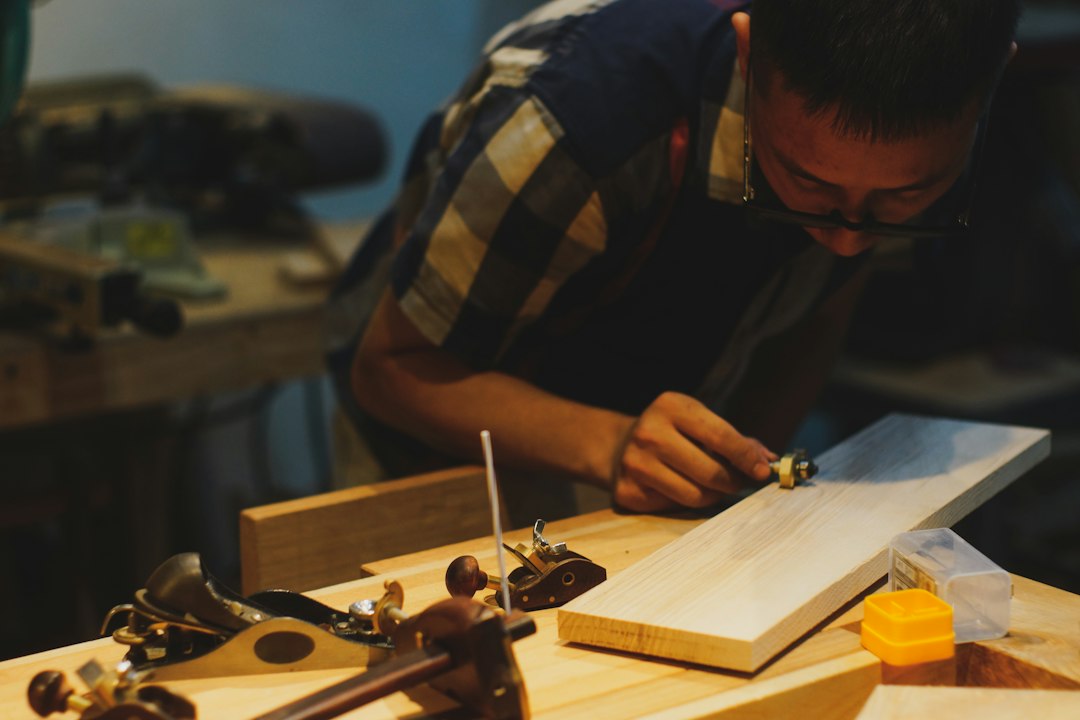 Carpenter working on wood with tools in workshop